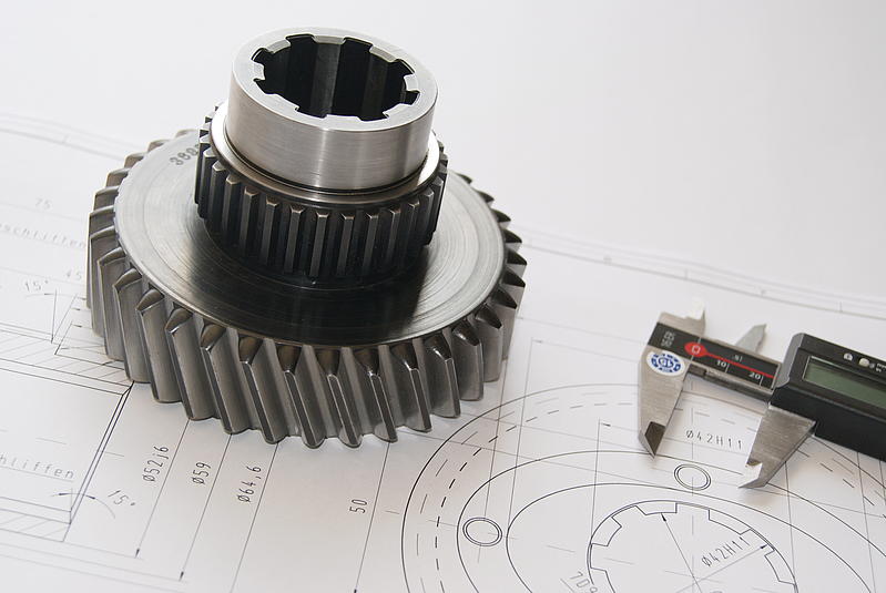 Spur gear lies on technical drawing